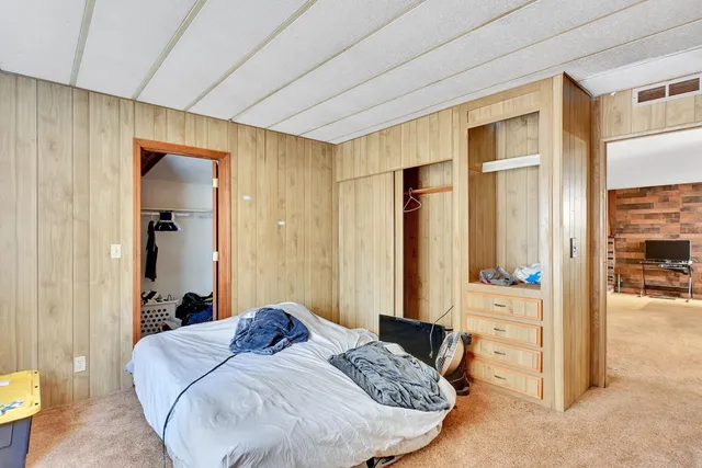 a bathroom with a granite countertop sink a toilet and shower