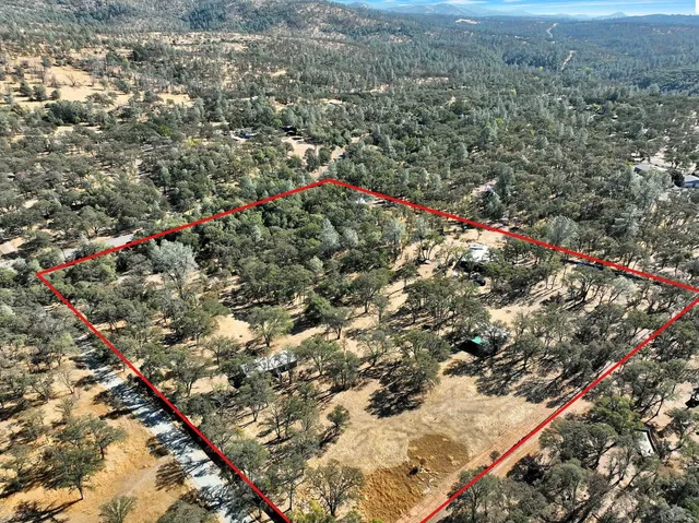 a view of a yard with snow on the road