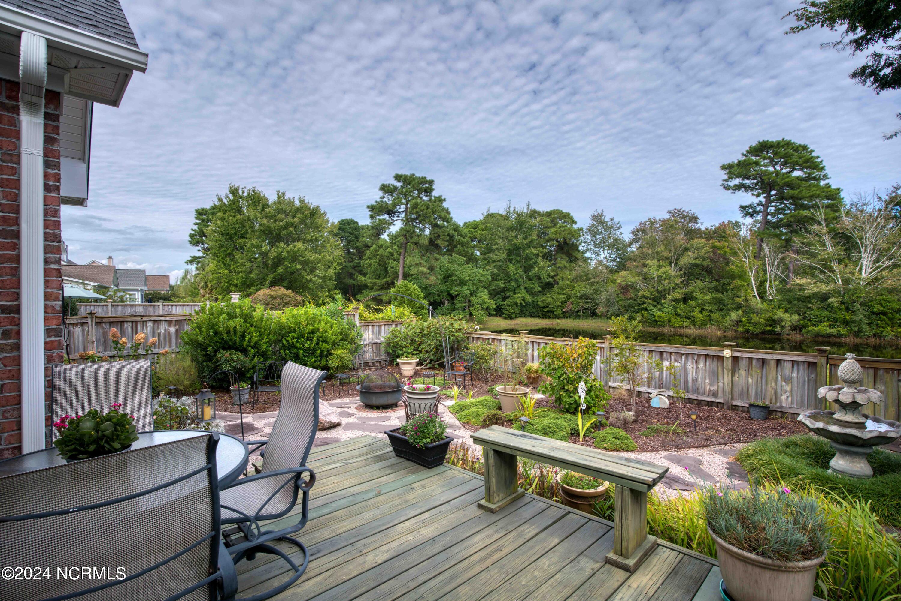 562 Tanbridge Road Wilmington, NC 28405 - Photo 3 of 72 Colorful backyard with deck & stone patio
