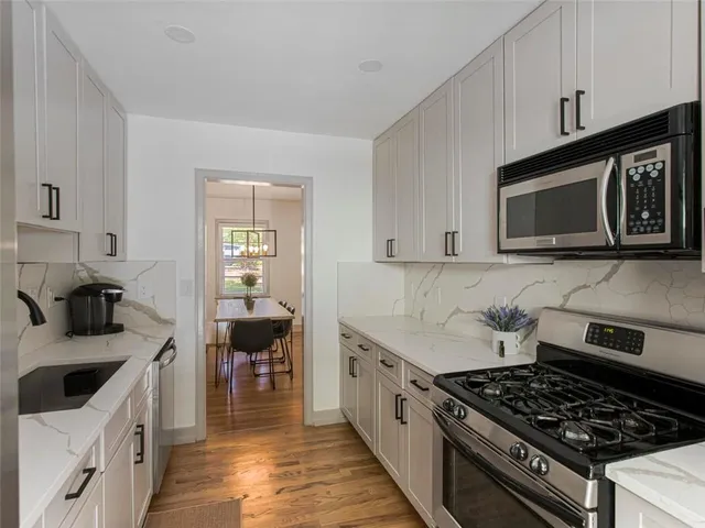a kitchen with stainless steel appliances a stove a microwave and cabinets