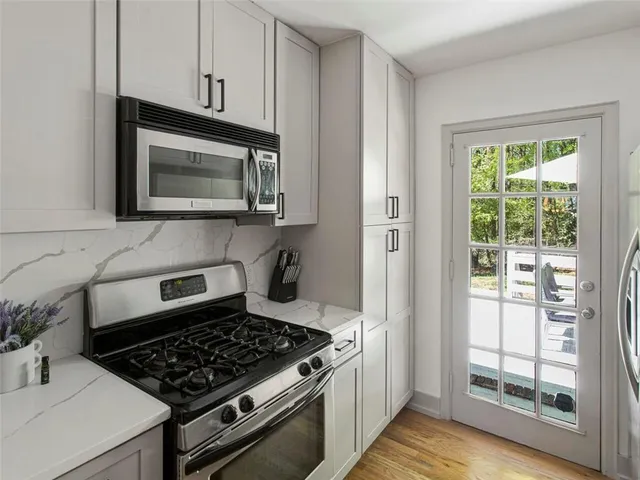 a kitchen with appliances a sink and cabinets