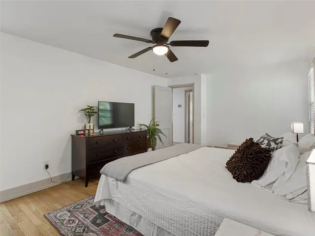 a bedroom with a bed and a ceiling fan