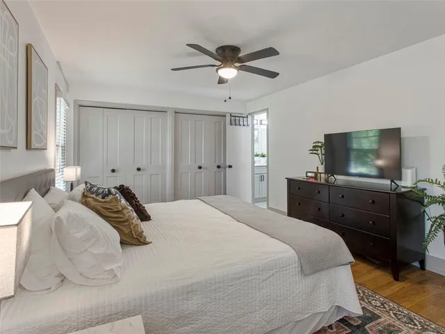 a bedroom with a bed and a flat screen tv