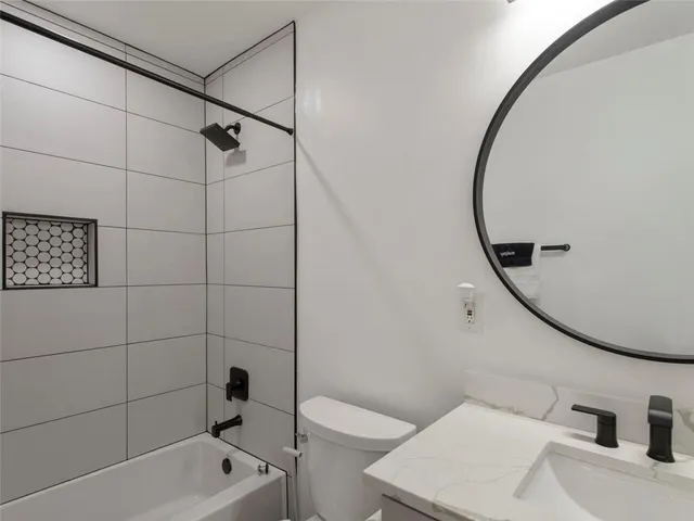 a bathroom with a toilet and a bathtub