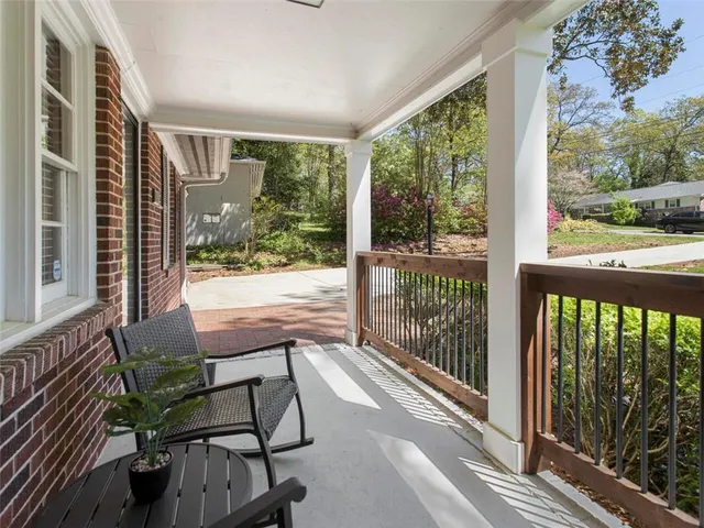 a view of a porch with chairs and wooden floor