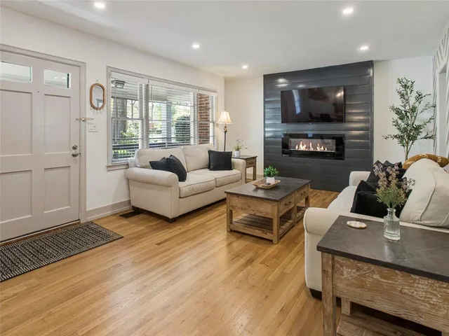a living room with furniture fireplace and a flat screen tv