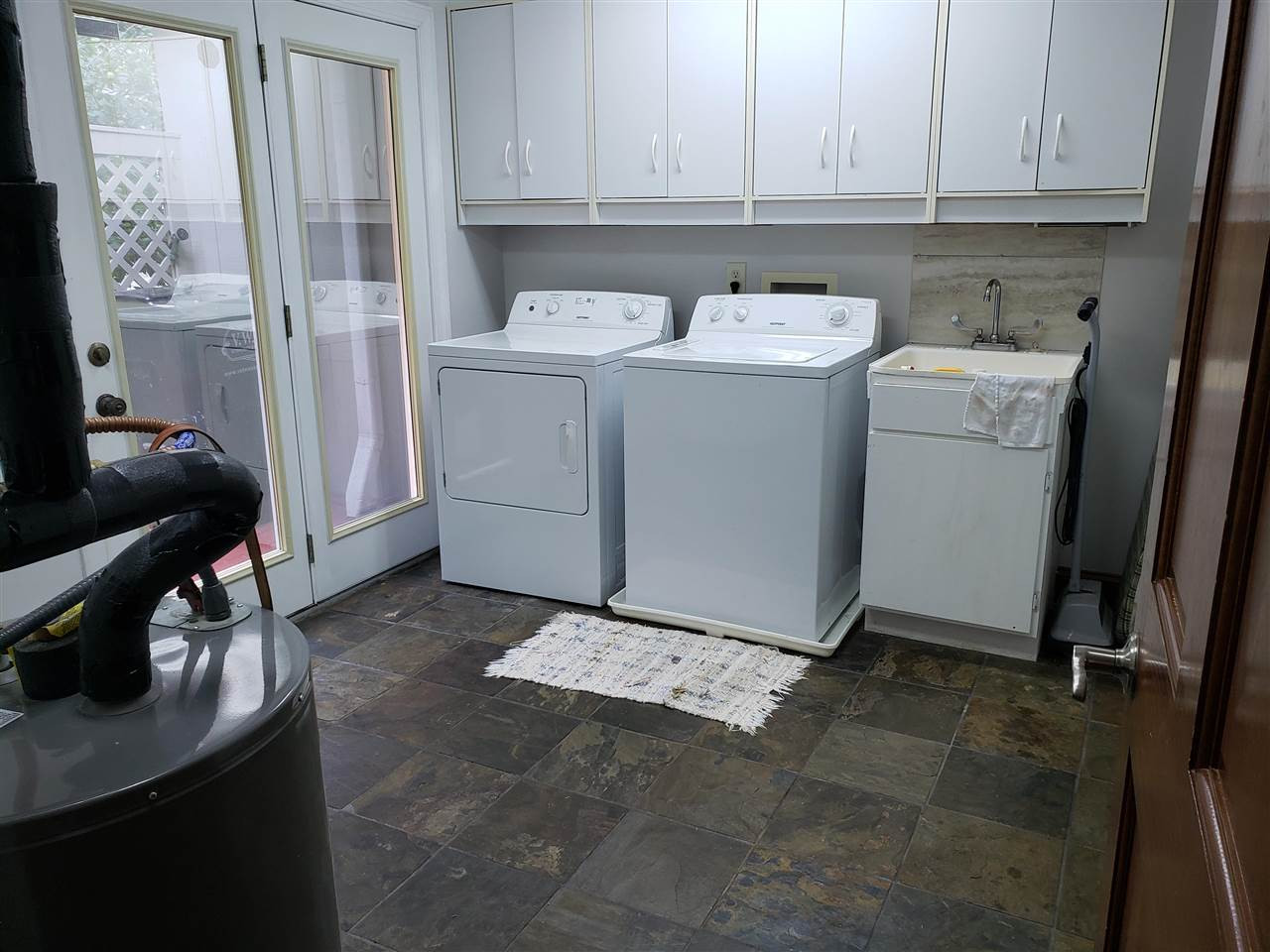 8529 Sawyer Drive Raleigh, NC 27613 - Photo 7 of 28 Large laundry room off kitchen. Also has heated and cooled slate floors, wash basin, storage cabinets, & access door to outside. Laundry