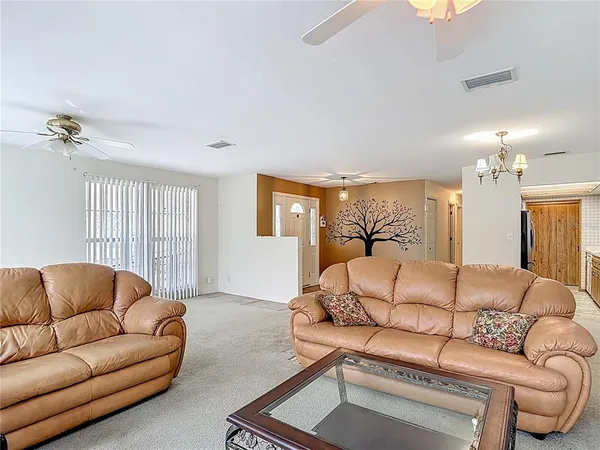 a living room with furniture a fireplace and a large window