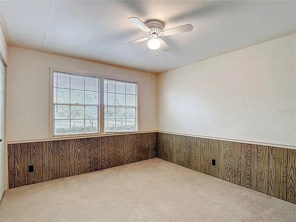 a large room with a large window and furniture