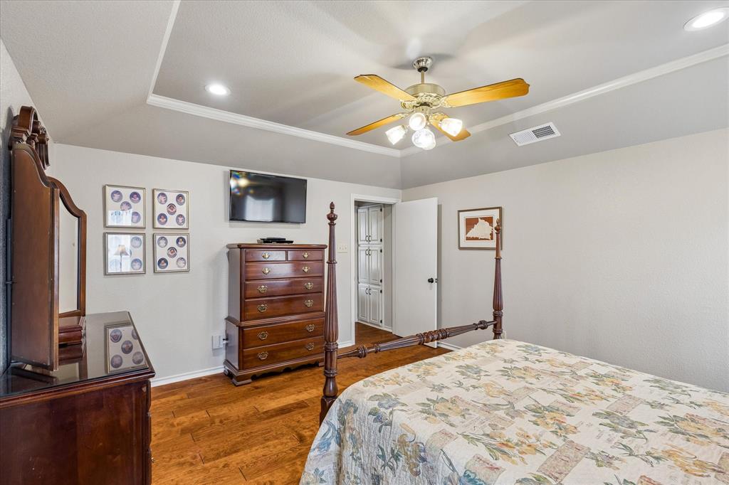 404 Moonlight Lane Keller, TX 76248 - Photo 21 of 40 a bedroom with a bed and a flat screen tv