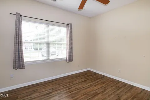 a view of a room with wooden floor