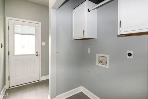 a view of an empty room with closet and a window