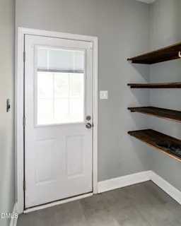 a view of green field with trees in the background