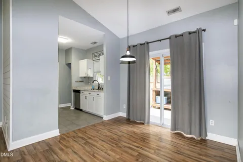 a view of a kitchen with a refrigerator and a stove top oven