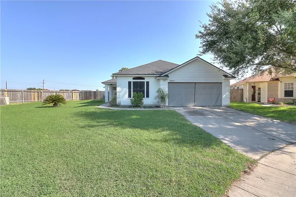 a front view of house with yard and green space