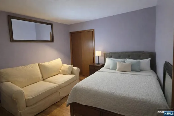 a bedroom with bed and a couch