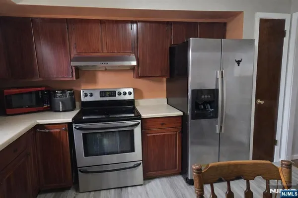 a kitchen with a stove and a refrigerator