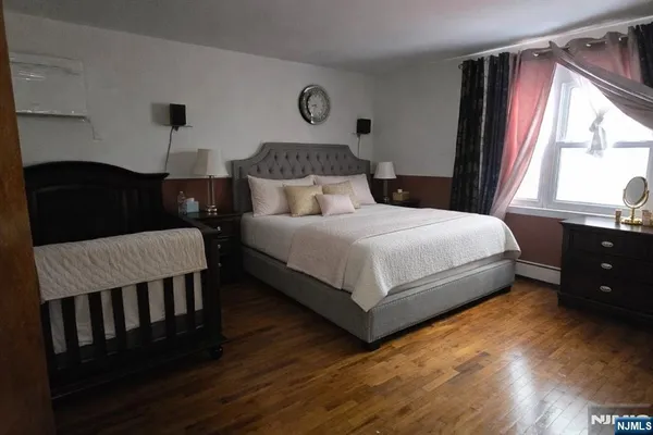 a bedroom with a bed lamp closet and window