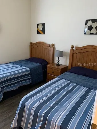 a bedroom with bed and wooden floor