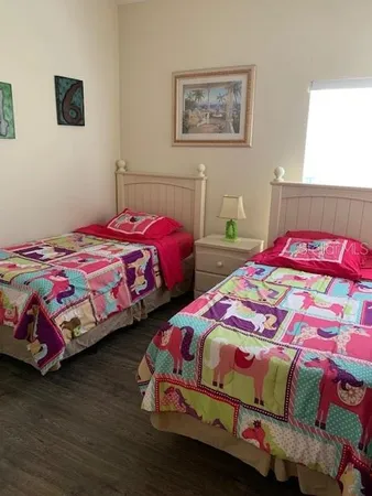 a bedroom with two beds and painted walls