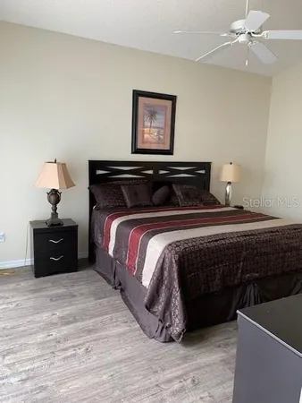 a bedroom with a bed and a lamp on dresser