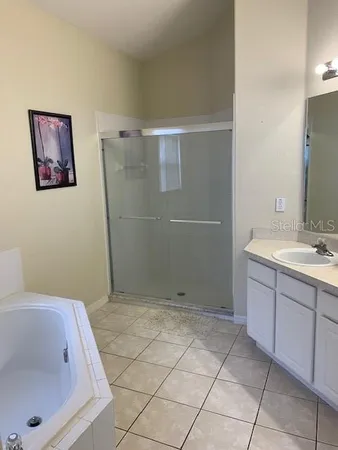 a bathroom with a bathtub and shower