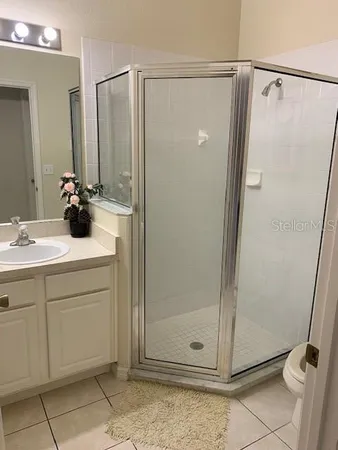 a bathroom with a shower and a sink
