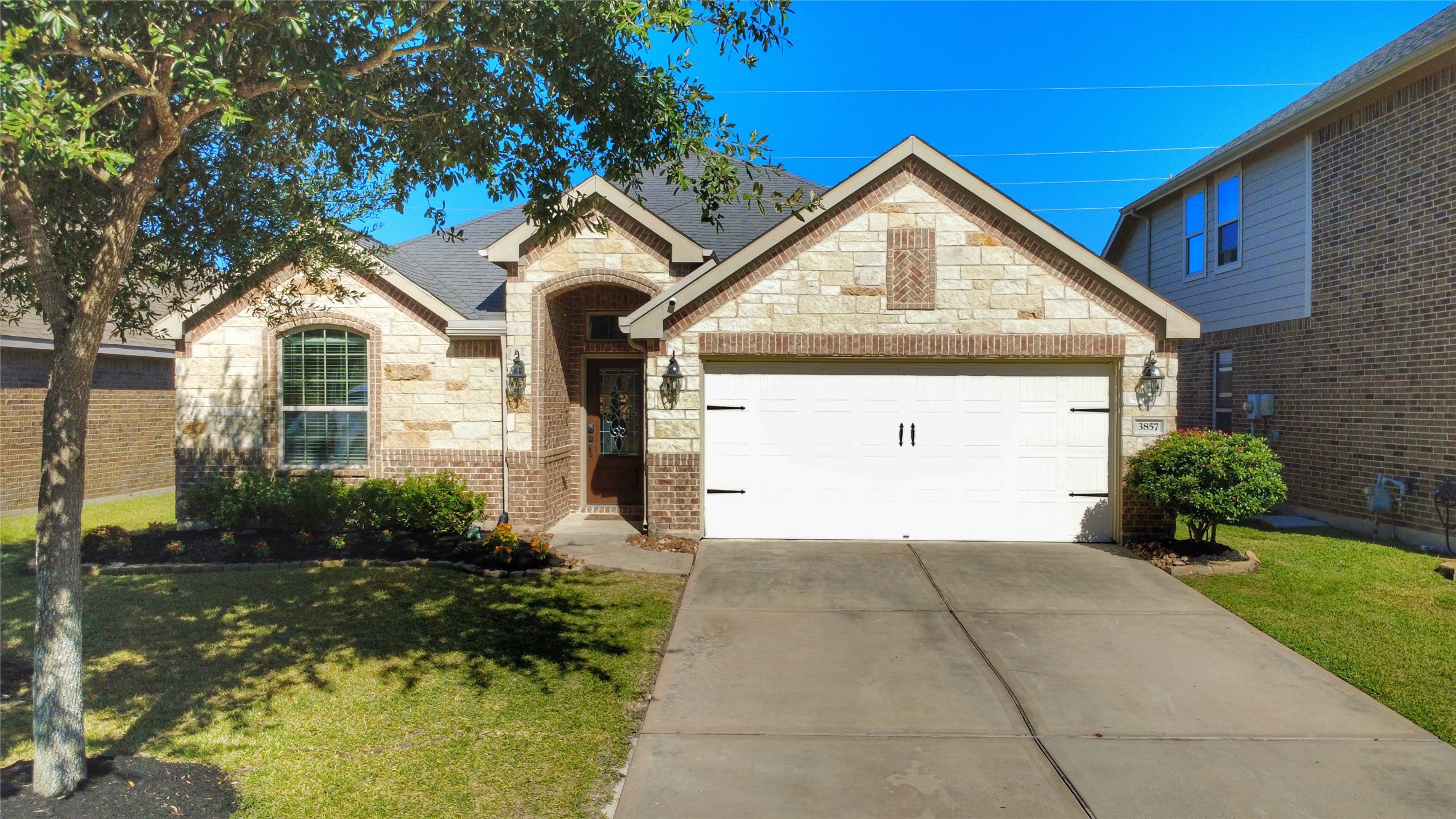 3857 Enchanted Timbers Lane Spring, TX 77386 - Photo 1 of 39 a front view of a house with garden