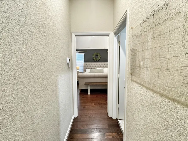 a view of bedroom with a bed and a hallway
