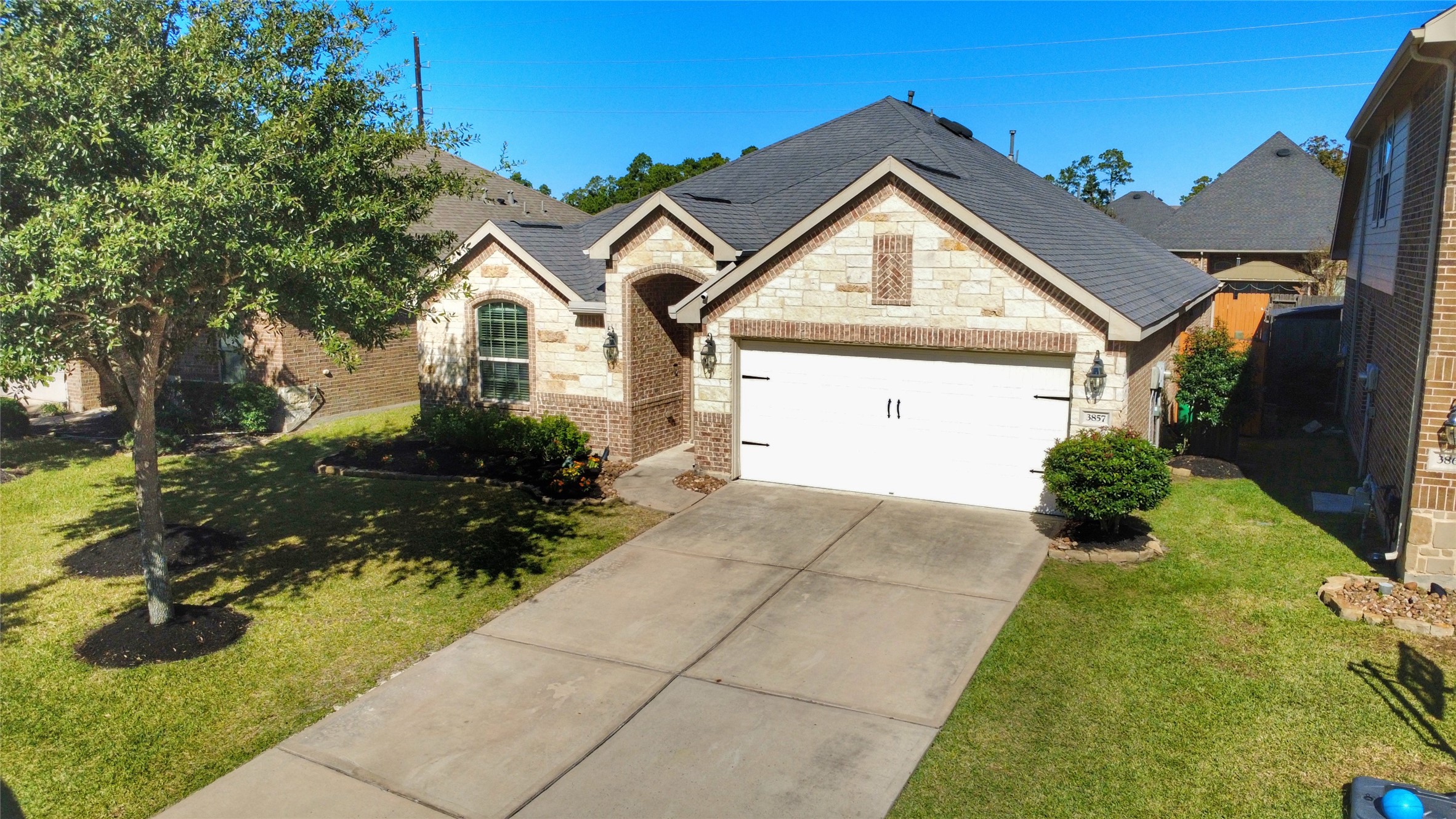 3857 Enchanted Timbers Lane Spring, TX 77386 - Photo 2 of 39 a front view of a house with garden