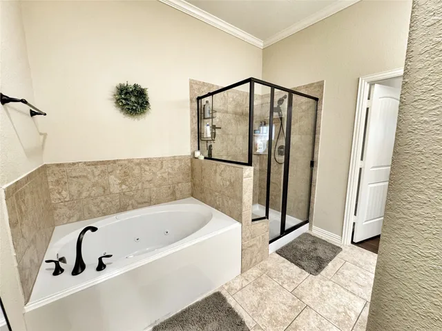 a bathroom with a bathtub and shower