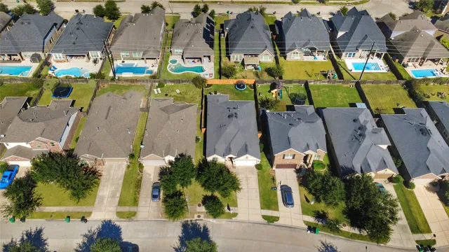 an aerial view of residential houses with outdoor space