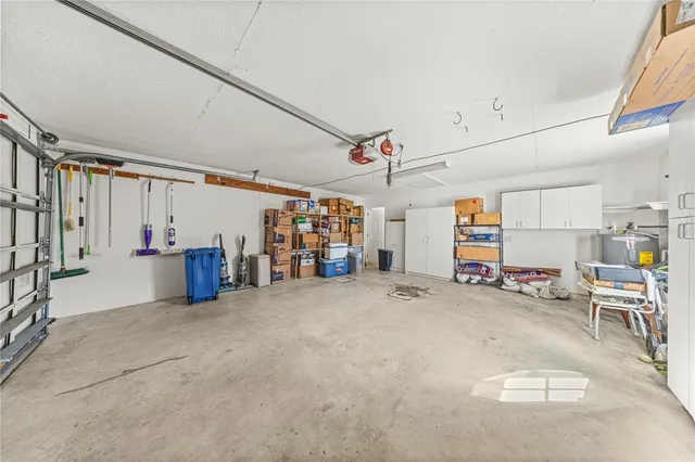 a spacious bedroom with a bed and a chandelier