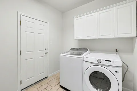 a view of storage and utility room with washer and dryer