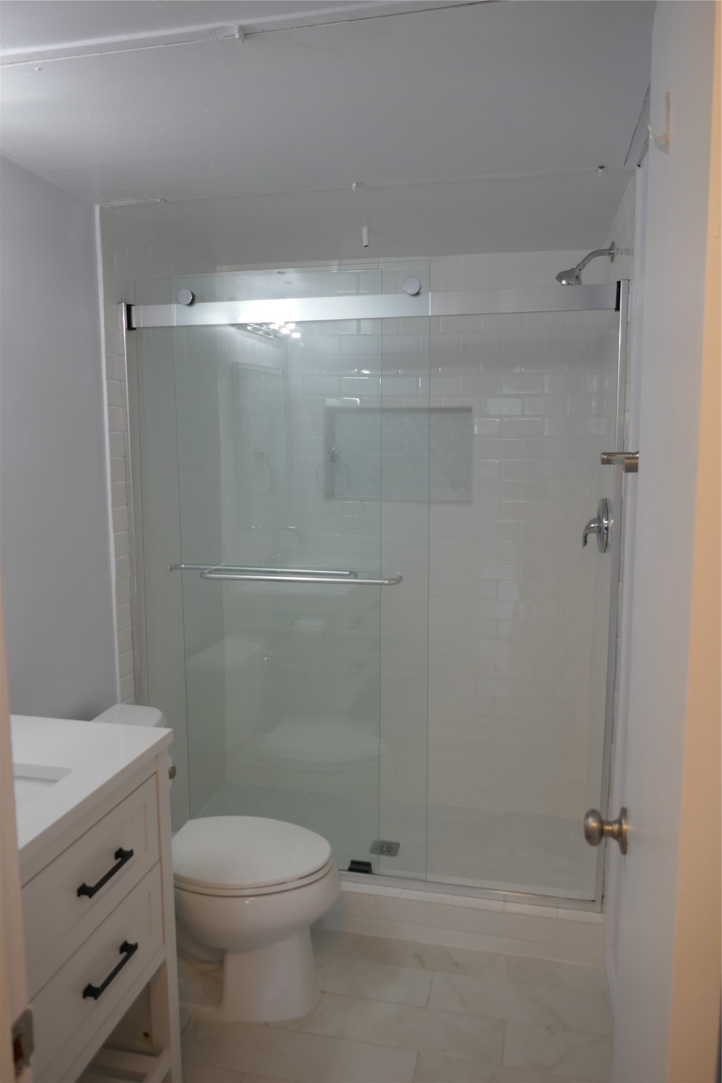 2100 Tanglewilde Street, Unit 347 Houston, TX 77063 - Photo 12 of 19 a bathroom with a shower a toilet and a sink