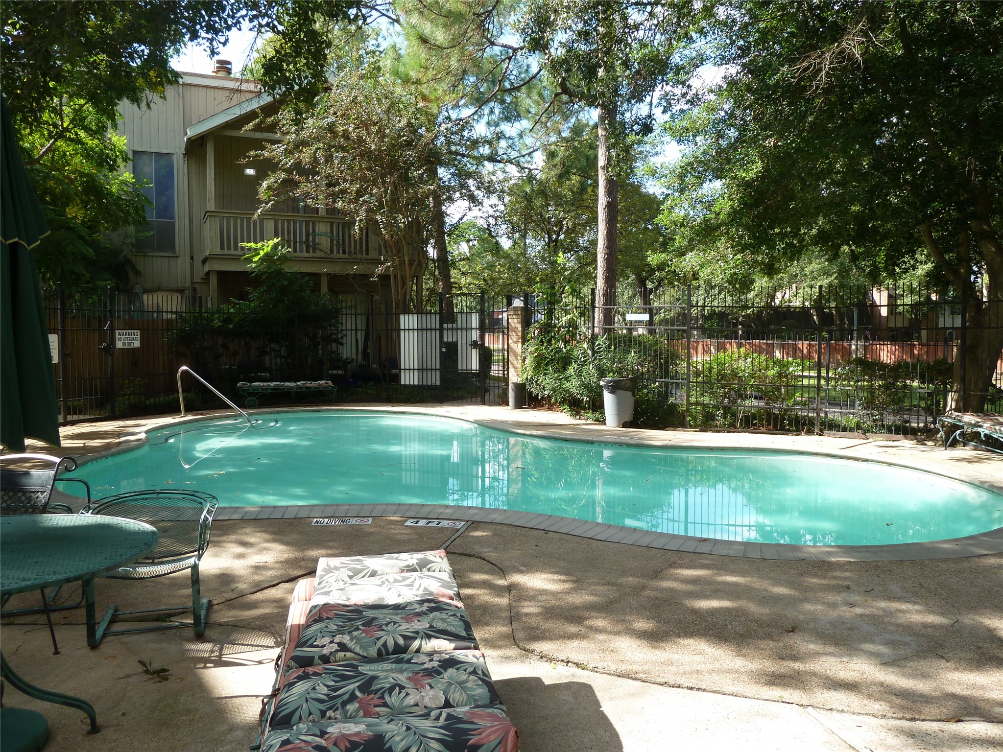 2100 Tanglewilde Street, Unit 347 Houston, TX 77063 - Photo 15 of 19 a view of backyard with table and chairs and potted plants and large trees