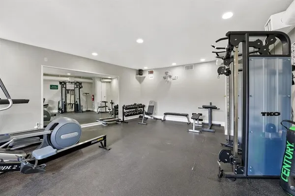 a room with gym equipment and a table