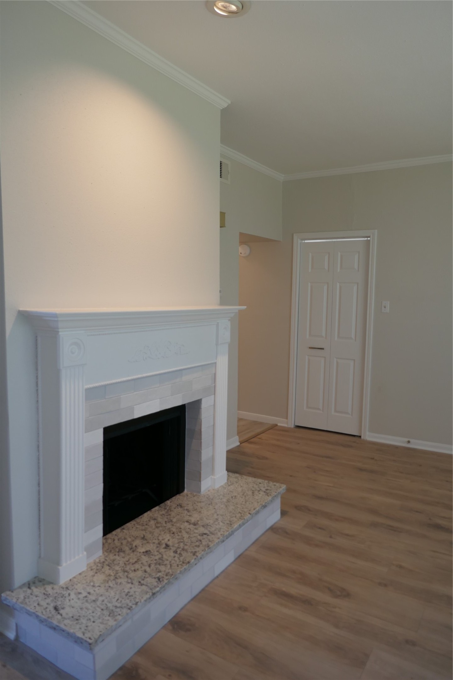 2100 Tanglewilde Street, Unit 347 Houston, TX 77063 - Photo 6 of 19 a view of empty room with wooden floor and fireplace
