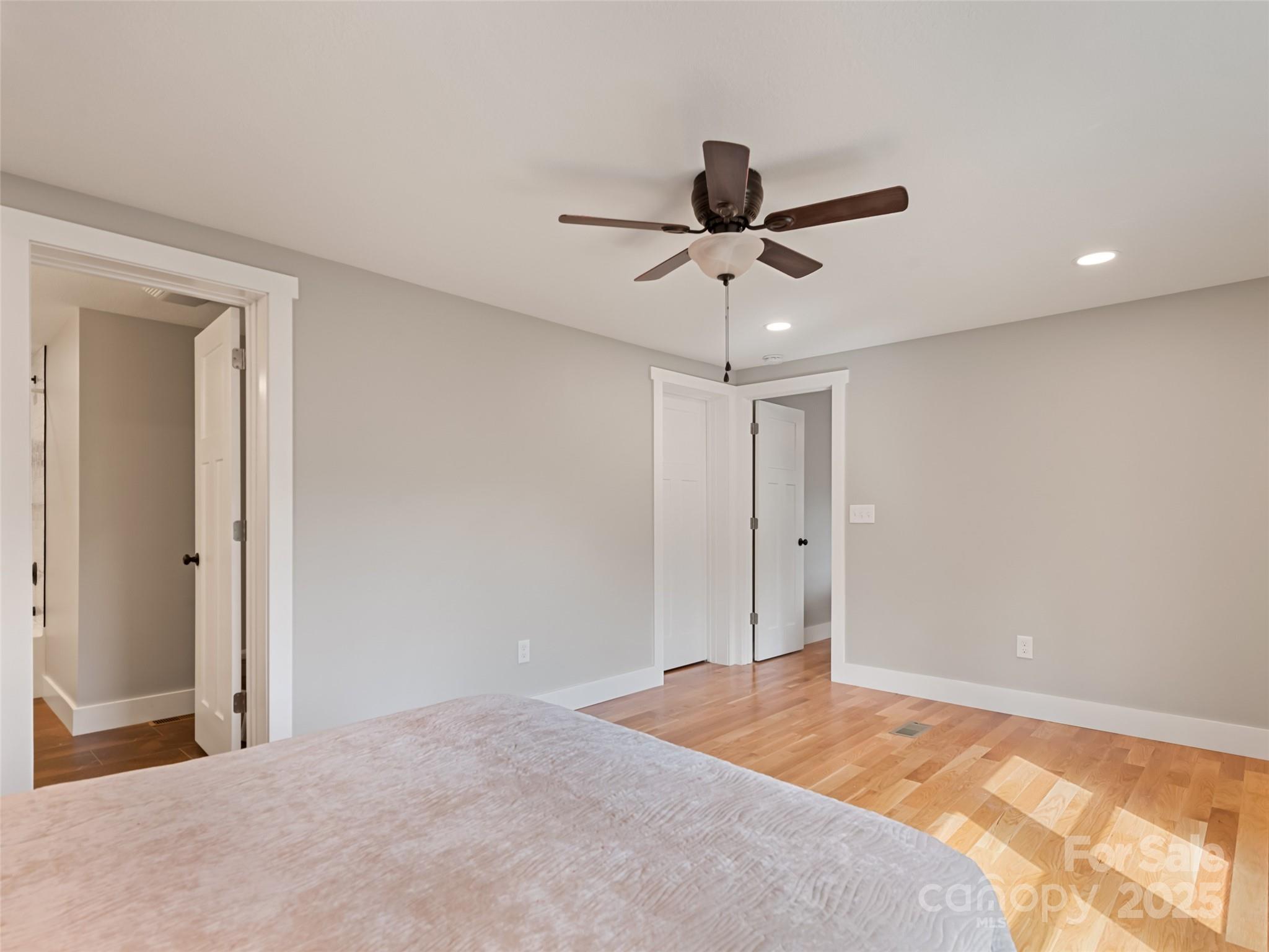 120 Simonds Ridge Canton, NC 28716 - Photo 24 of 36 a bedroom with a bed and a chandelier fan