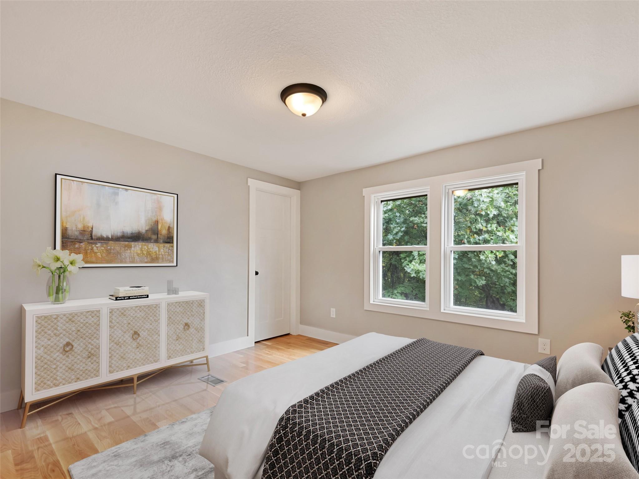 120 Simonds Ridge Canton, NC 28716 - Photo 25 of 36 a bedroom with a bed and a painting on the wall