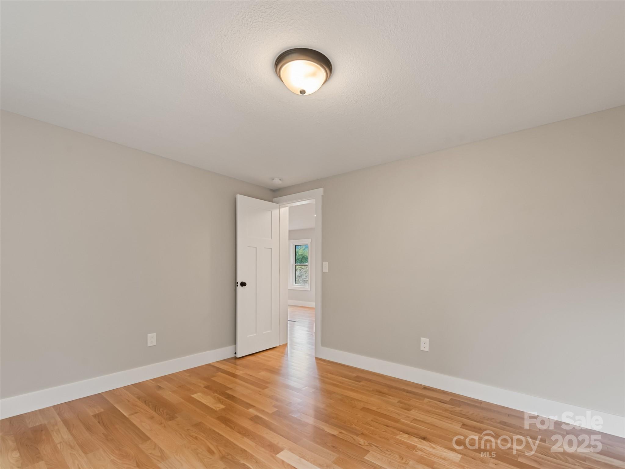 120 Simonds Ridge Canton, NC 28716 - Photo 26 of 36 a view of an empty room with wooden floor