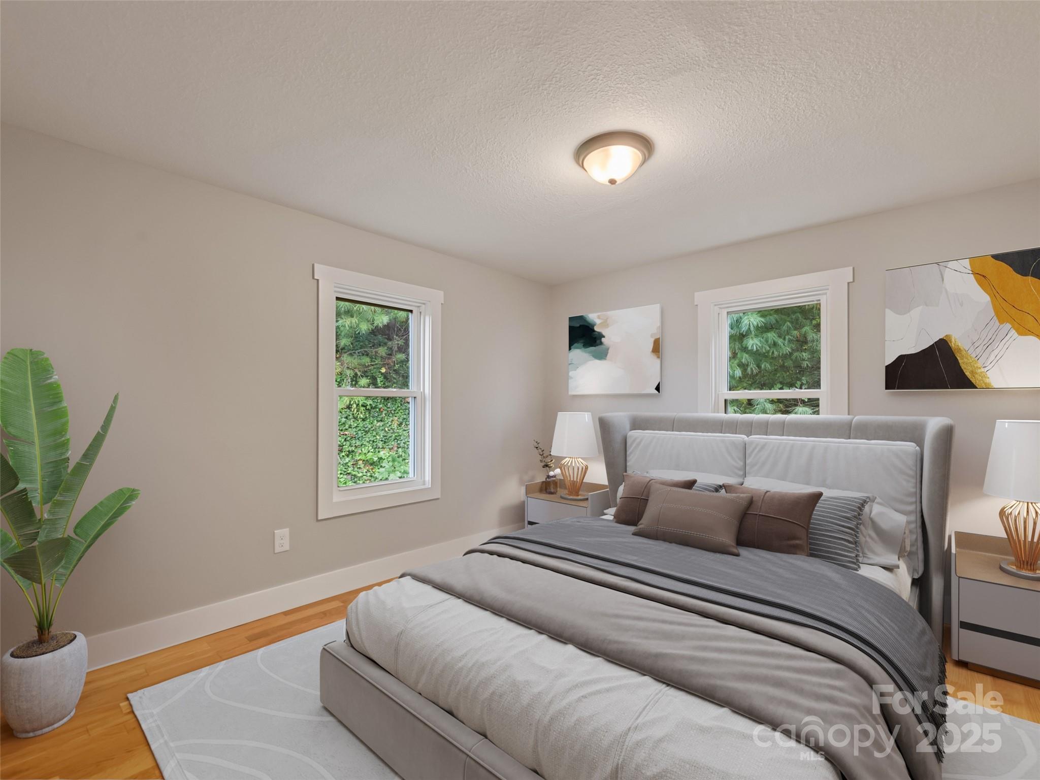 120 Simonds Ridge Canton, NC 28716 - Photo 27 of 36 a bedroom with a large bed and a potted plant