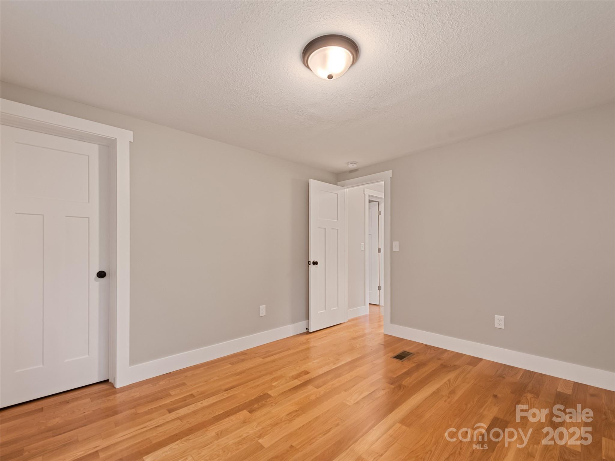 120 Simonds Ridge Canton, NC 28716 - Photo 28 of 36 a view of an empty room with wooden floor