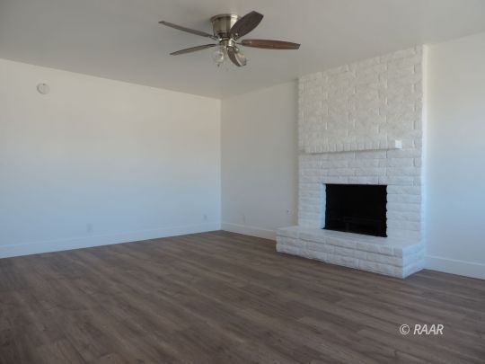 709 West Alene Avenue Ridgecrest, CA 93555 - Photo 3 of 20 a view of empty room with wooden floor and fireplace