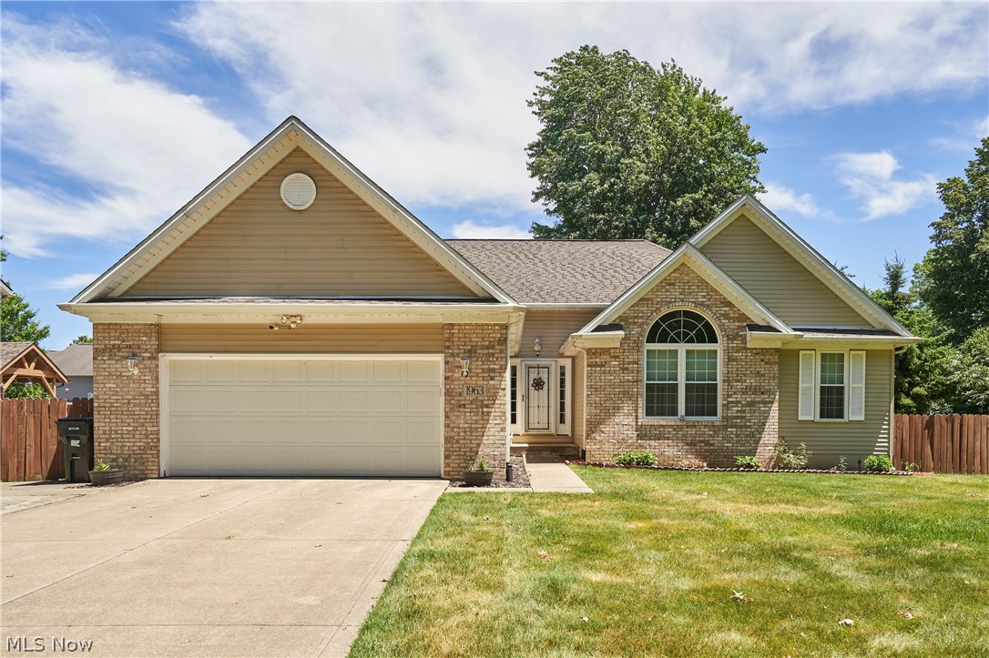 1963 Haines Road Madison, OH 44057 - Photo 1 of 34 Traditional style residence featuring a brick and siding exterior, an attached two-car garage, and a gabled roofline