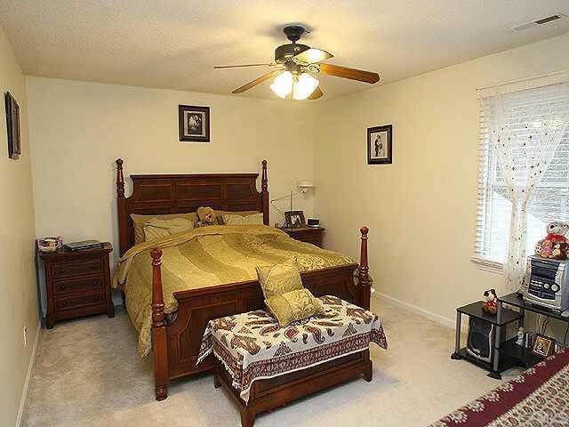 6704 Twin Tree Court Raleigh, NC 27613 - Photo 6 of 11 a bedroom with a bed and a chandelier