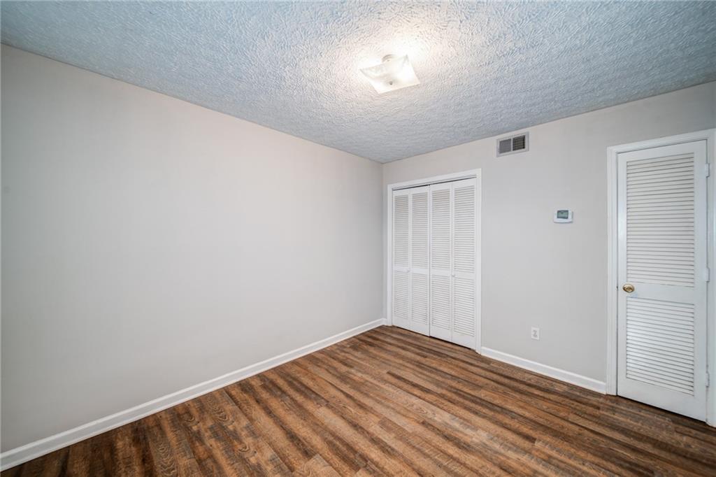 341 West Griffin Street, Unit C Dallas, GA 30132 - Photo 12 of 19 a view of empty room with wooden floor