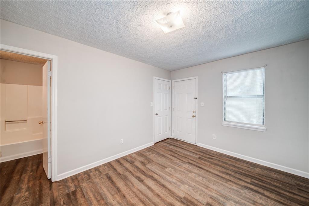 341 West Griffin Street, Unit C Dallas, GA 30132 - Photo 14 of 19 an empty room with wooden floor and windows
