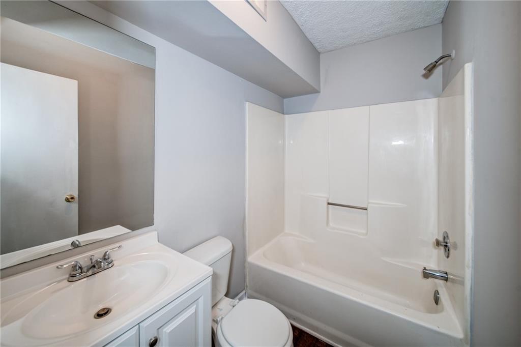 341 West Griffin Street, Unit C Dallas, GA 30132 - Photo 16 of 19 a bathroom with a sink toilet and bathtub