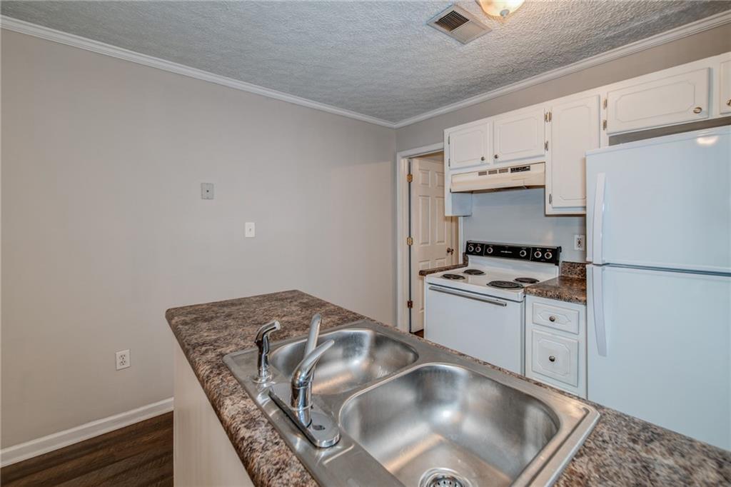 341 West Griffin Street, Unit C Dallas, GA 30132 - Photo 2 of 19 a kitchen with cabinets and appliances